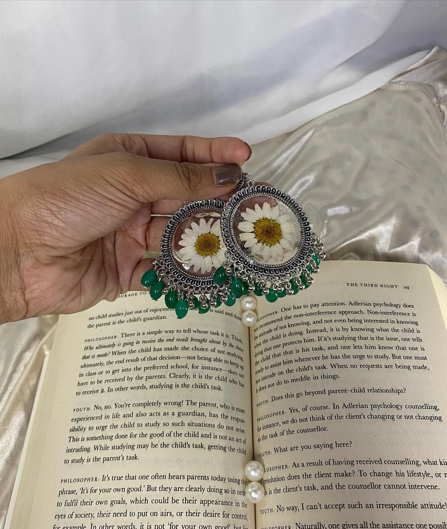 The pair arranged on cream satin