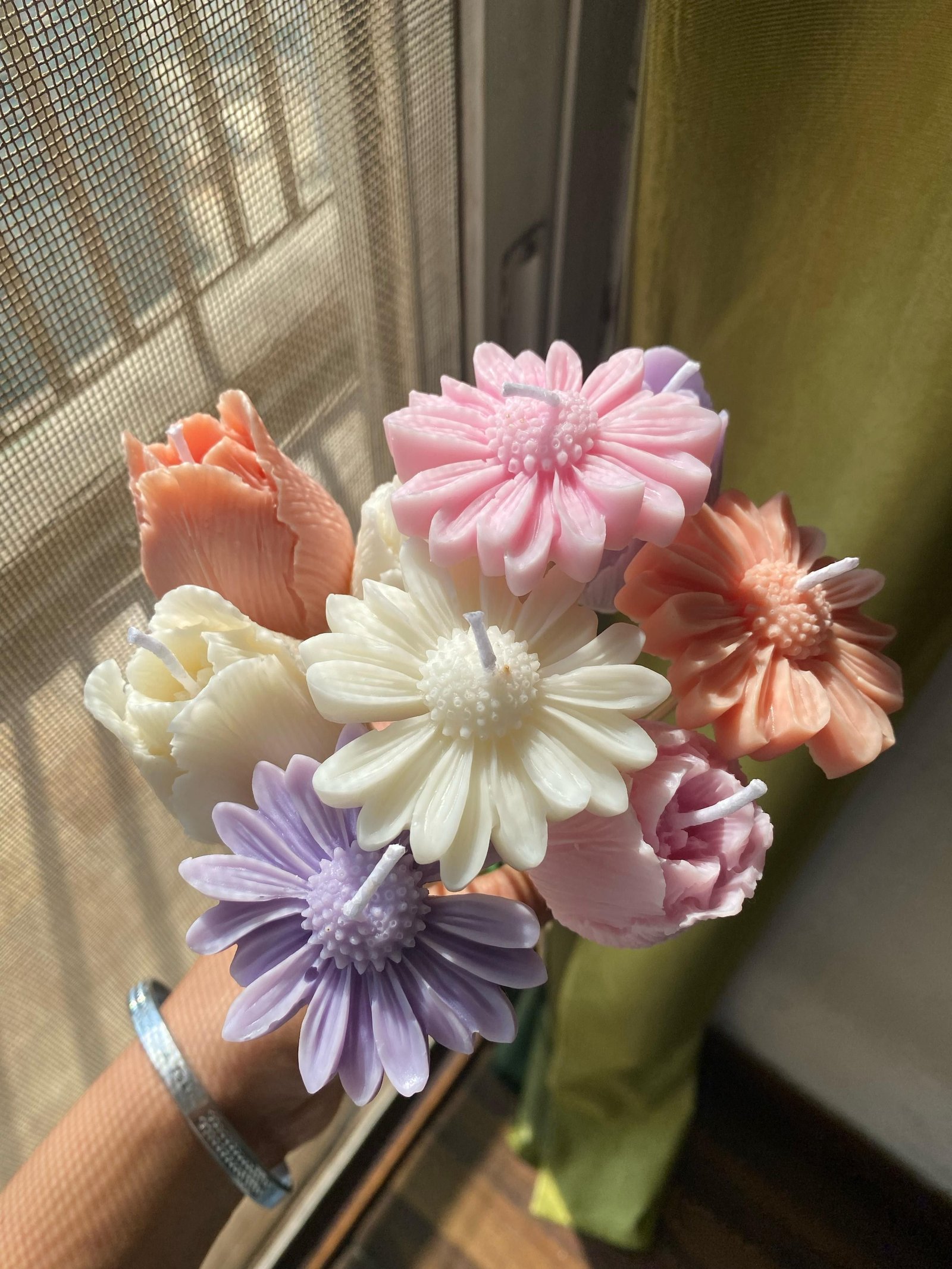 A smaller bunch of wax flowers held in the hand