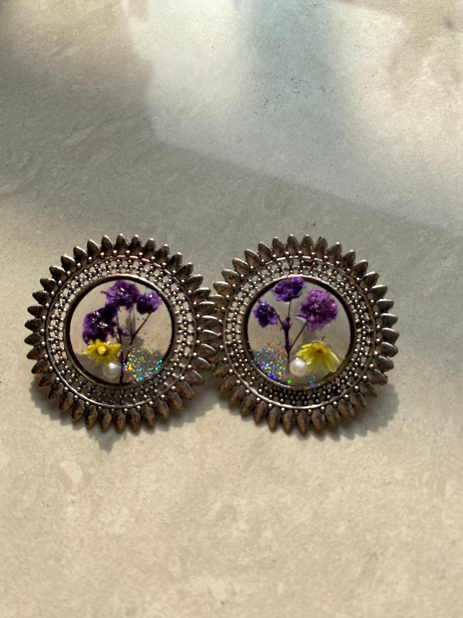 The same studs made with purple and yellow flowers