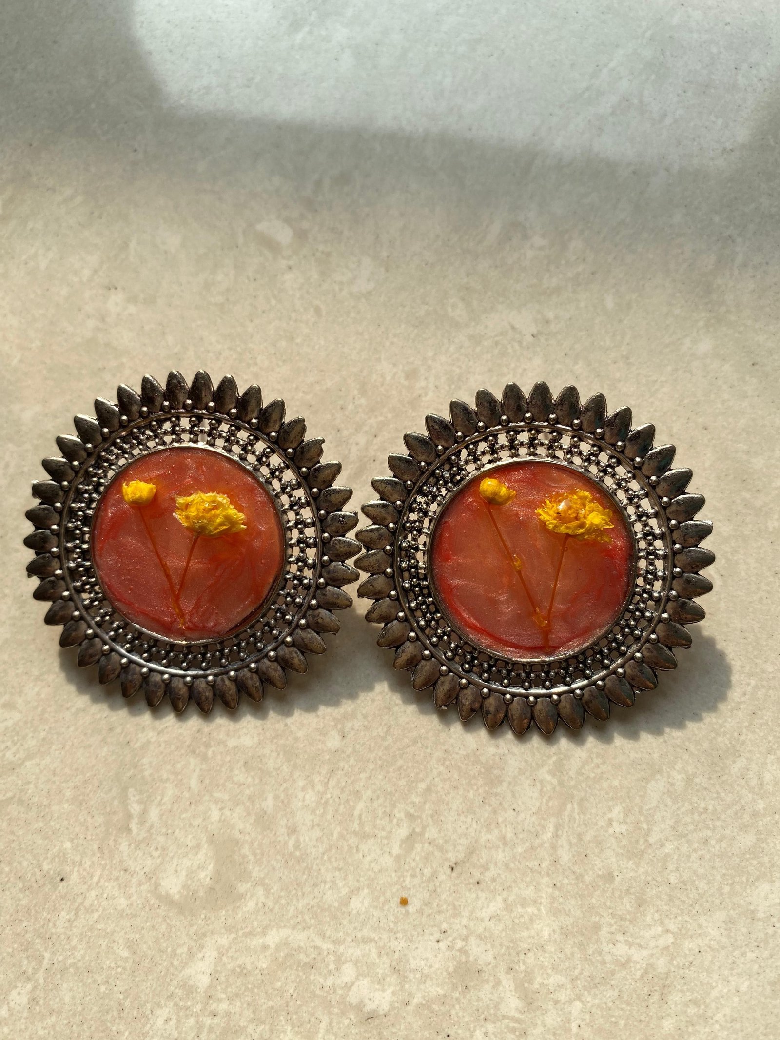A warmer pair, orange and yellow blooms in clear resin