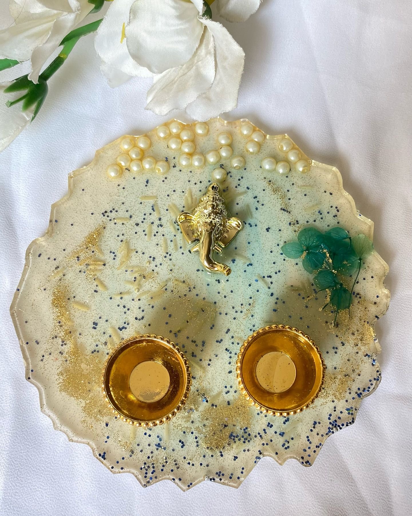 Two thalis arranged together with white flowers