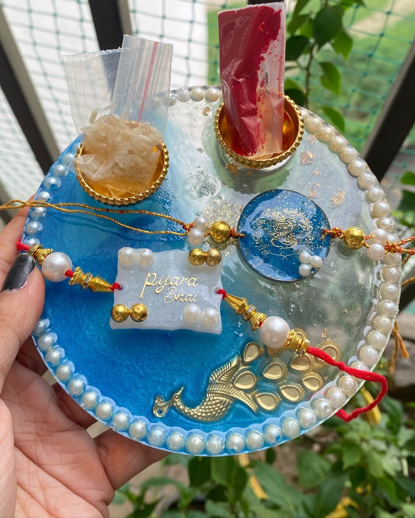 A closer view of the pearl rim and gold peacock
