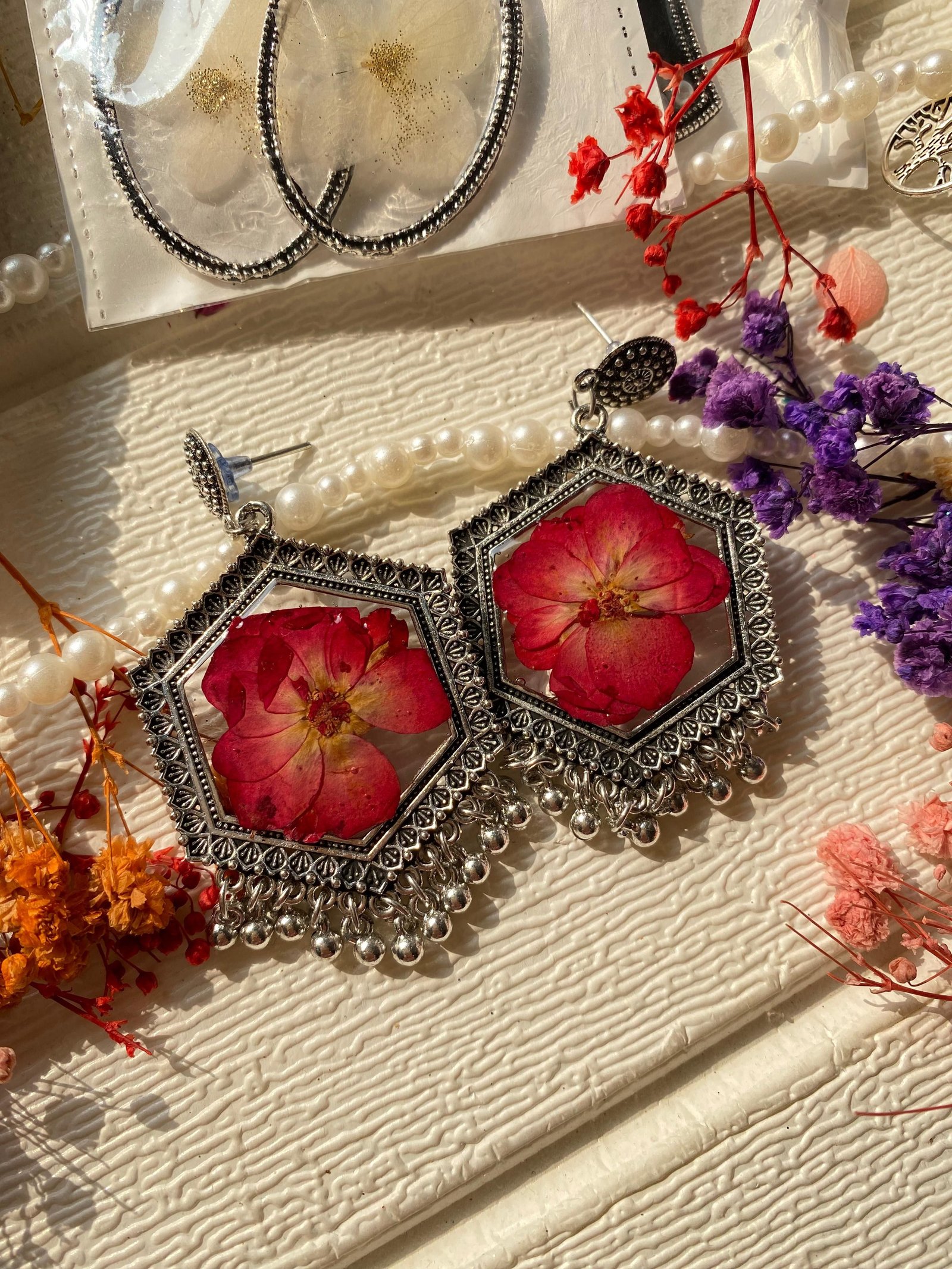 The pair seen closer, showing the red petals set into the resin
