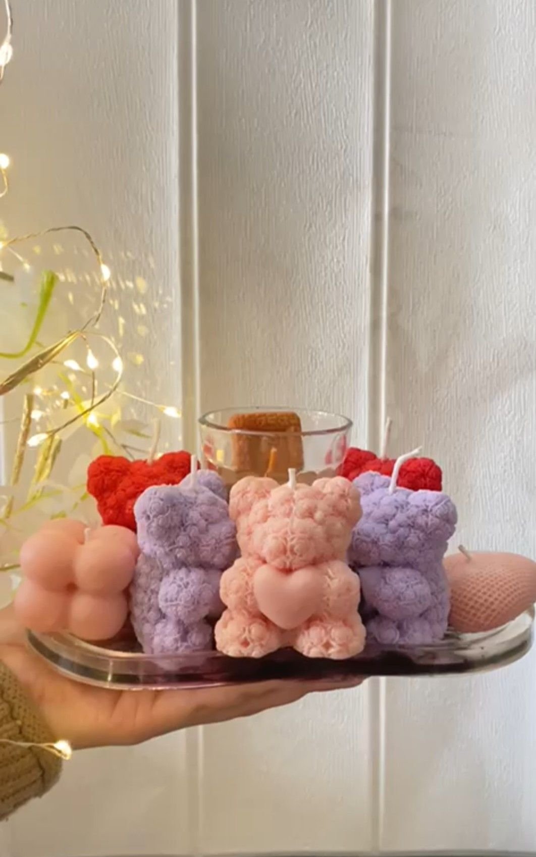 A tray of teddy bear candles in pink, lilac and cream